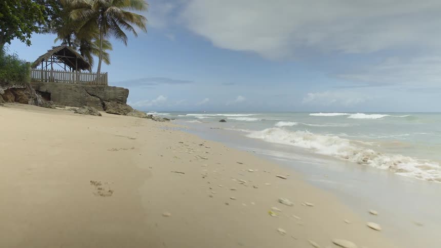 Ocean waves wash ashore a sandy beach