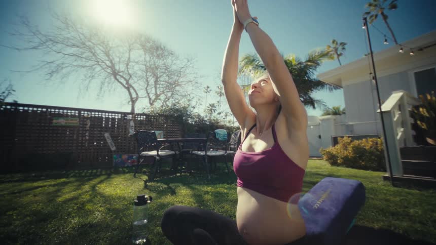 A woman doing yoga outdoors
