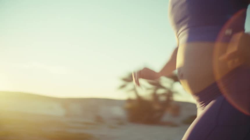 A woman running outdoors near the beach