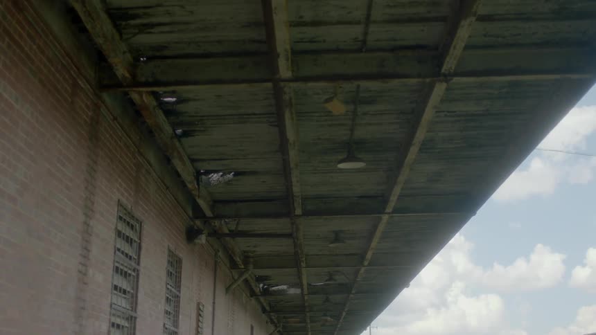 A warehouse with a stained overhang