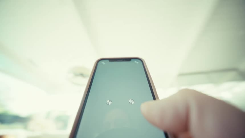 Smartphone held in hand displaying a blank screen