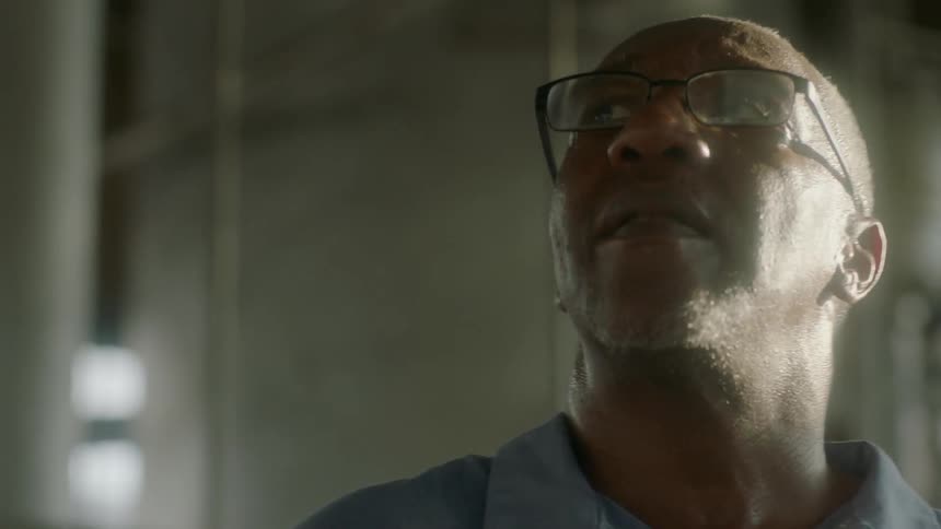 Older man inside building is looking around