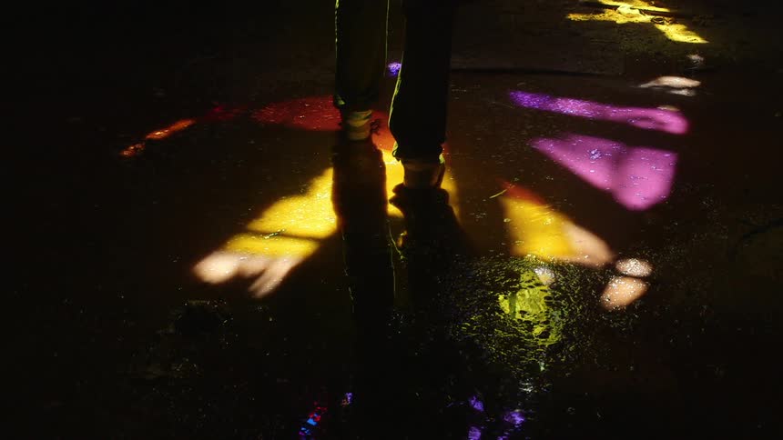 A man walks through a puddle