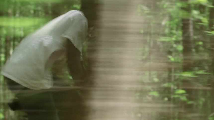 Man rides bike quickly through the woods