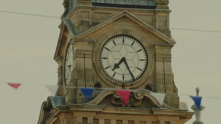 Closeup of an ornate concrete clock tower