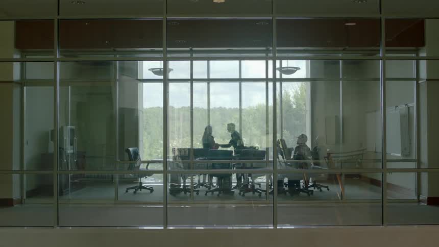 Person walks into a meeting at work