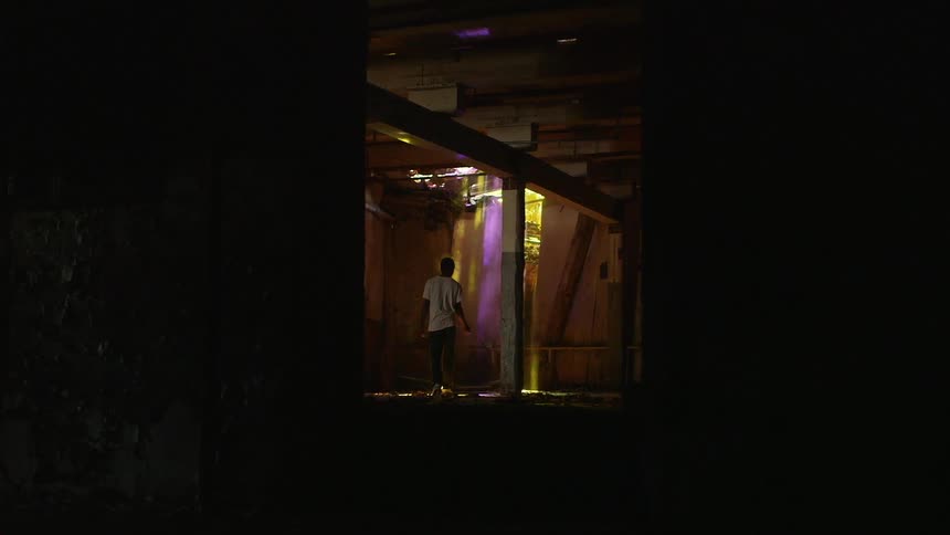 Man slowly walking in a barren building