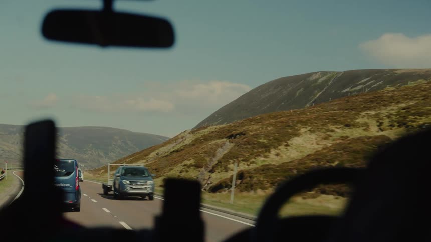 A view of some cars driving down a road