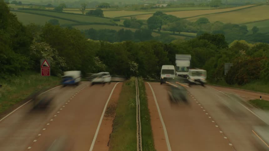 Traffic moving in both directions on a freeway in the mountains