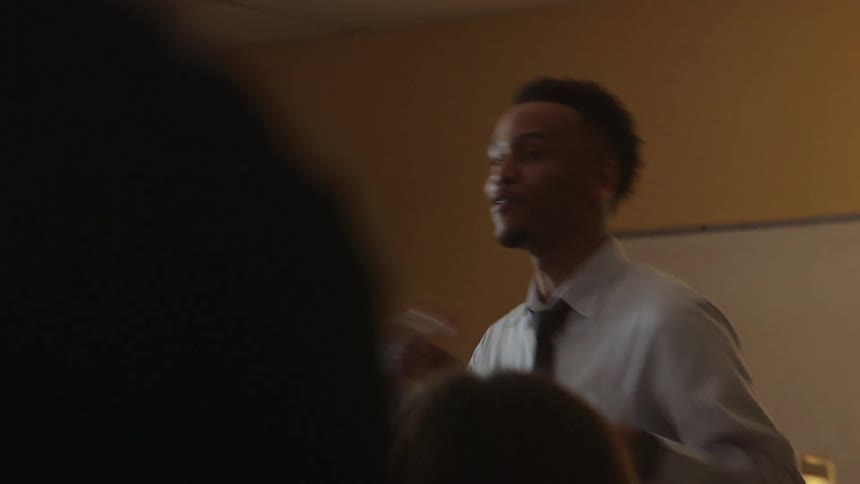 Man smiling as he teaches a class