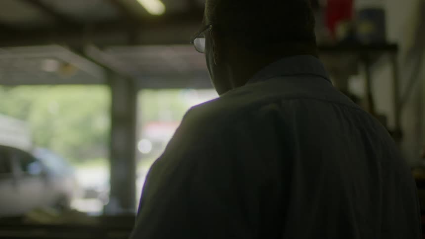 A man walks in a garage
