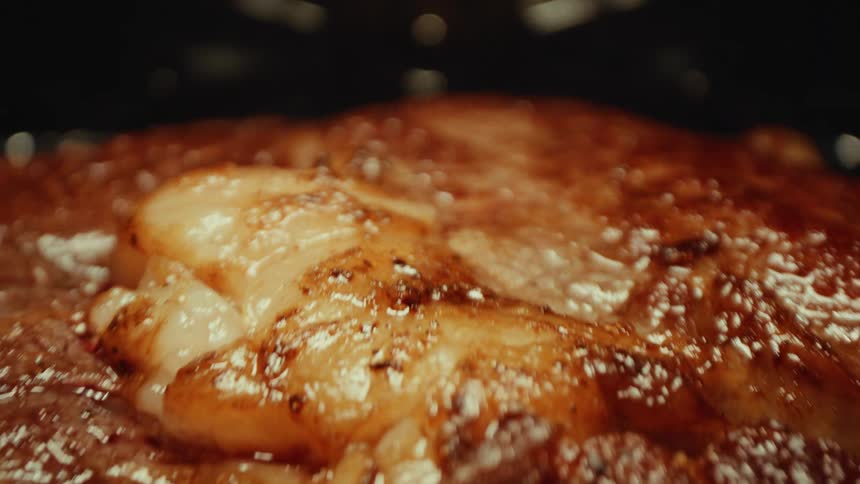 Meat cooking in the oven glistens