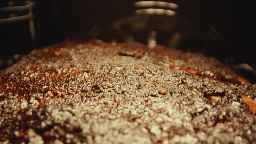 Meat roasts in the oven with coarse salt on the surface