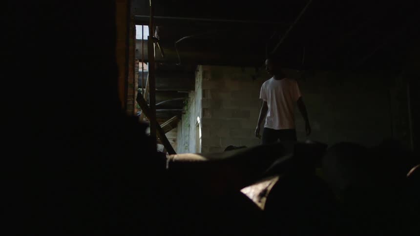 Man standing in a dim basement