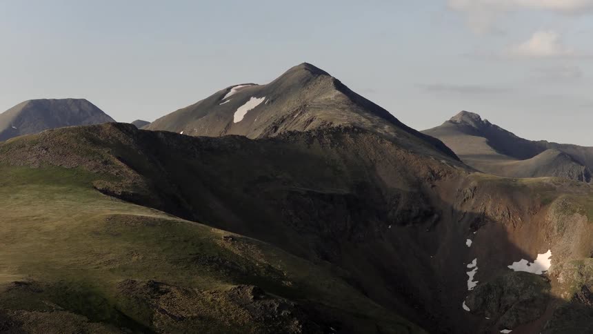 Aerial of a mountain range on a partly cloudy day