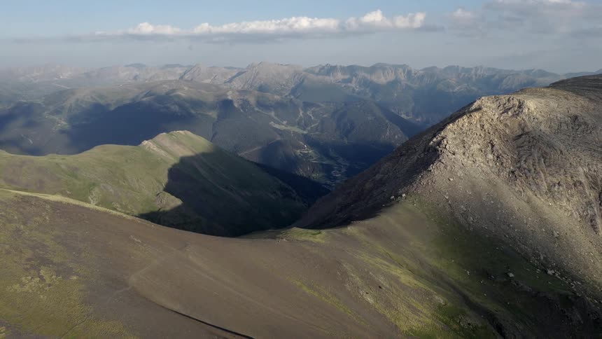 Light fog covers mountainous terrain on a cloudy day