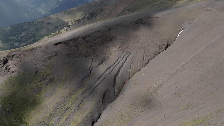Aerial view of a mountain ridge with signs of erosion from water on it