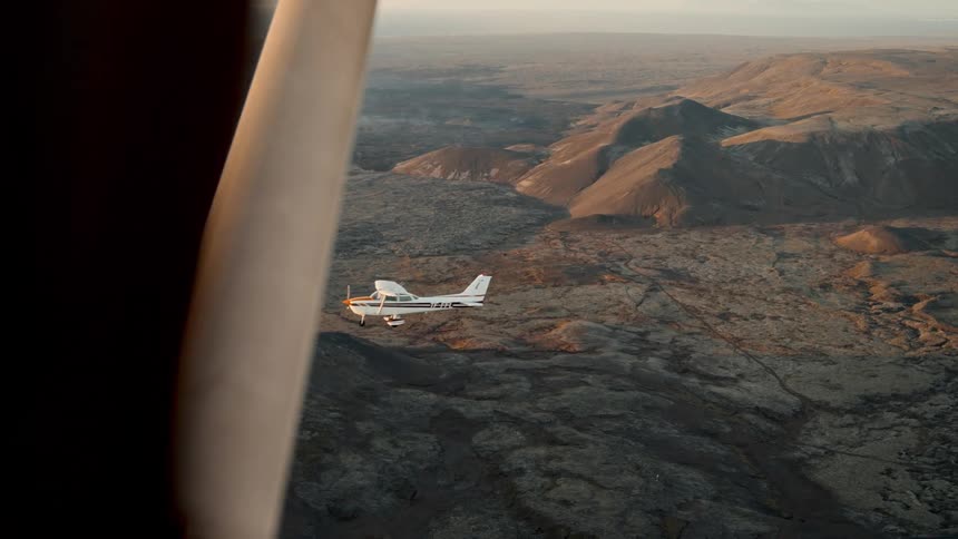 Two planes fly side by side over the canyon