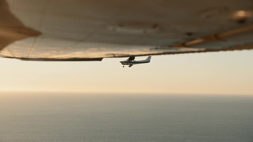 Two planes fly high over the ocean