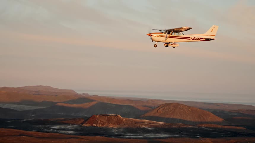 A plane flying over a desert area