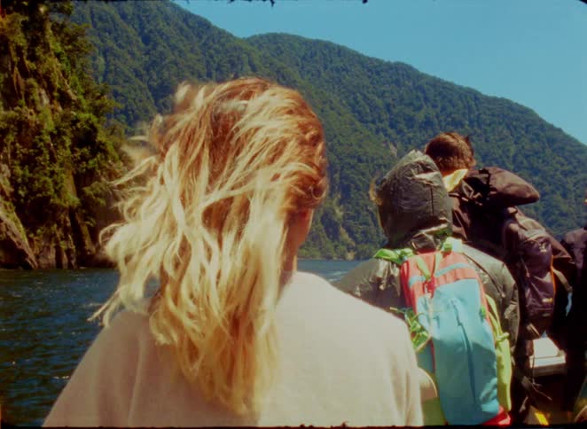 A group of people outdoors on a lake