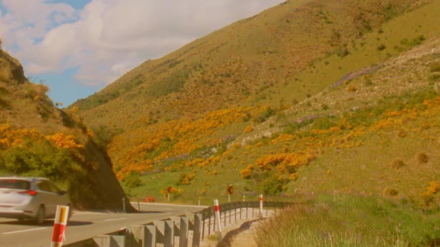 A car driving up a road in a mountain
