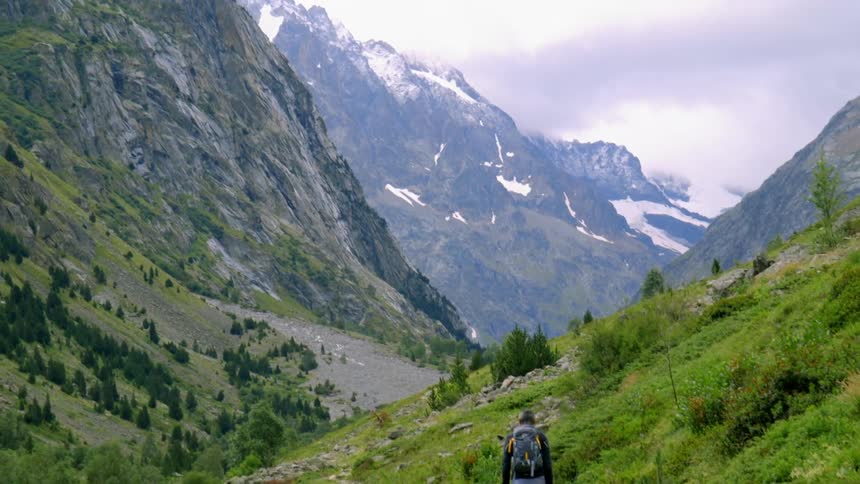 Man walks in a rocky mountainous landscape
