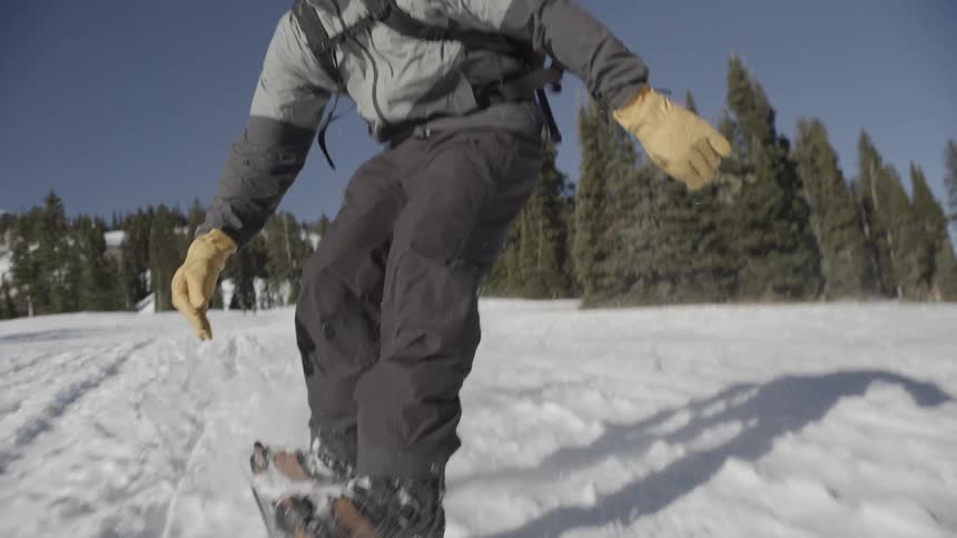 A man snowboarding down a mountain