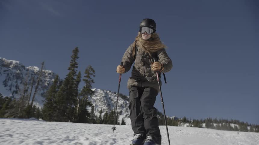 A woman skiing down a mountain
