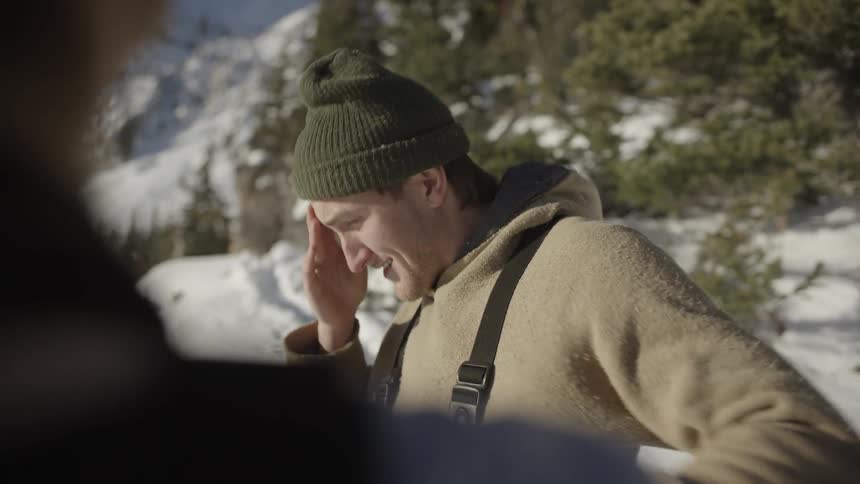 Two people talking in a snowy environment