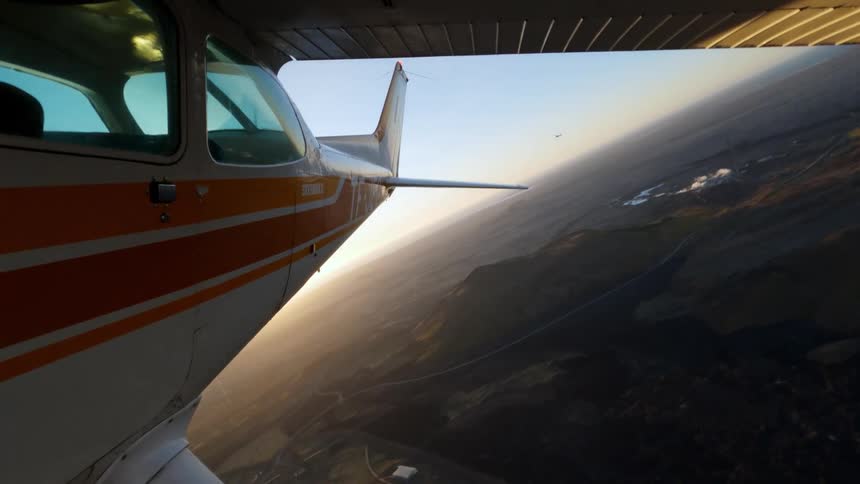 Small airplane in flight over the coast