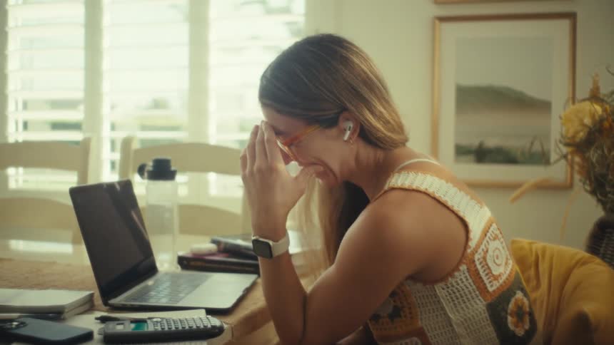 A woman talking on a laptop in a room