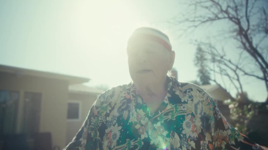 Man standing in his front yard singing and dancing