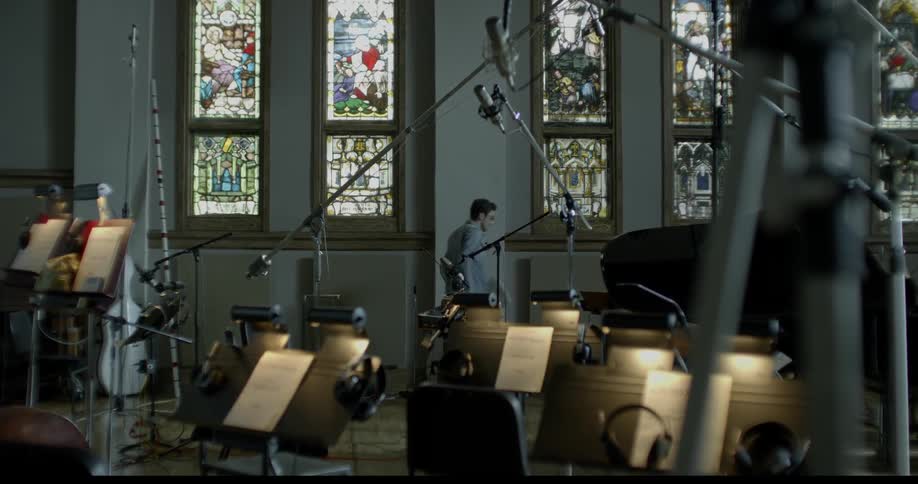 Man walks through a studio with instruments and stands