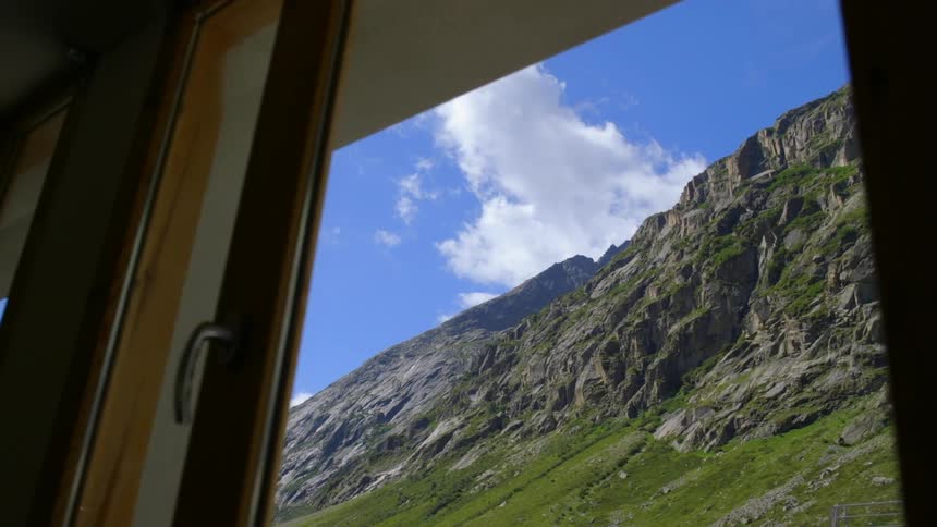 Outside the window you can see a tall mountain