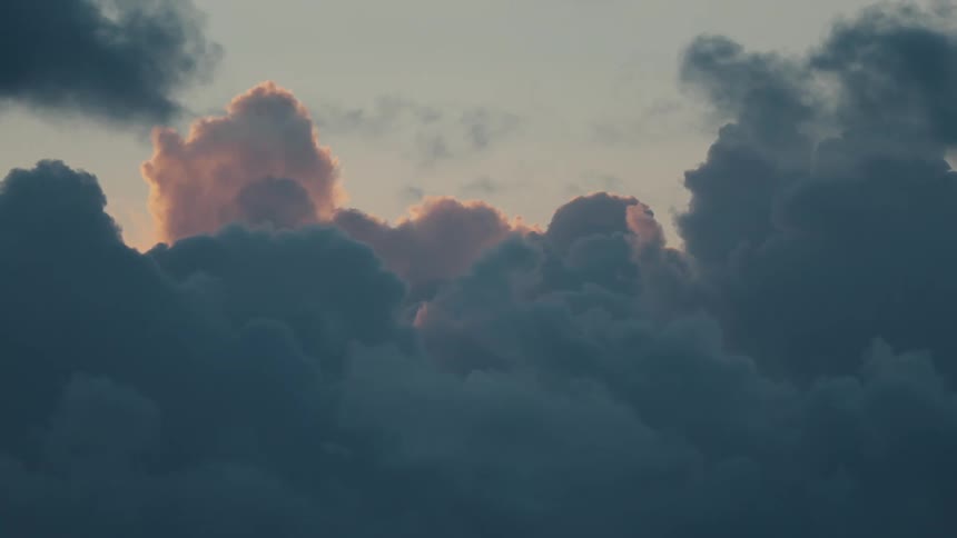 Fluffy clouds move across the sky