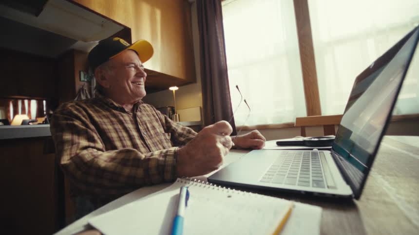 A man using a laptop in a room