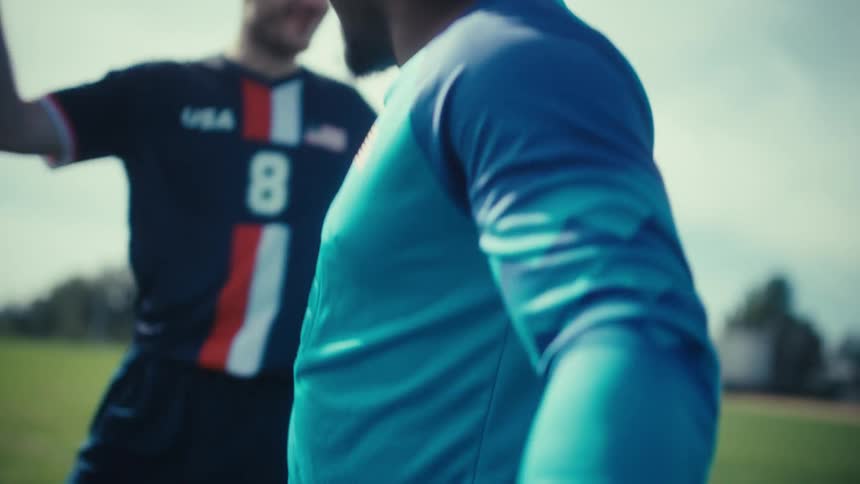 Players in blue jerseys hugging on field