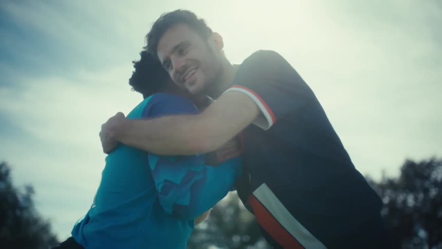 Two soccer players shaking hands