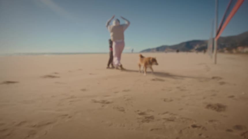 A mother chasing her child on the beach