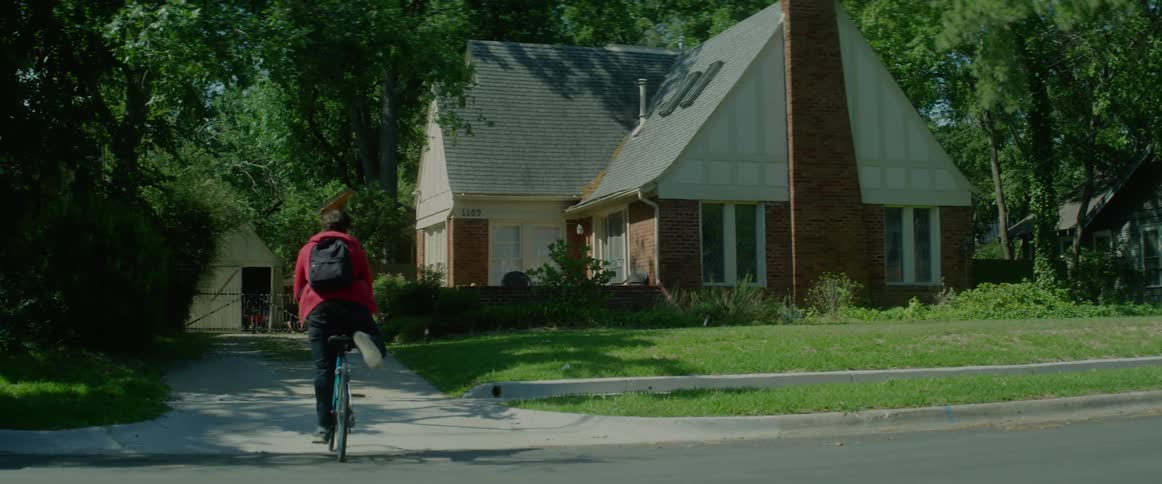 A man bikes into his driveway