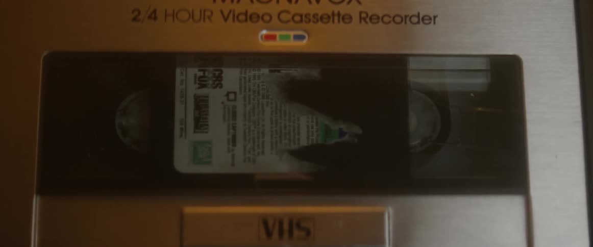 Close-up of a video cassette tape moving in a machine