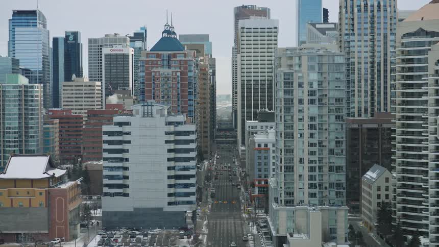 Wide aerial shot of a modern city skyline on a cold overcast day