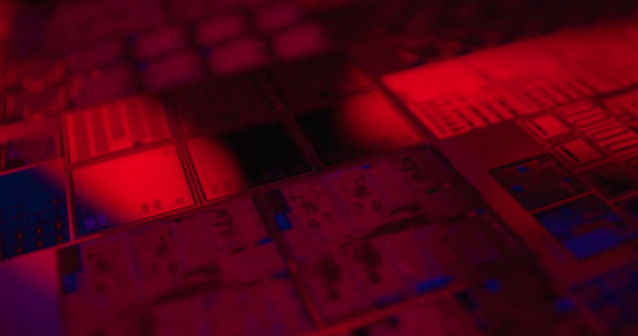 Microchip with modules and electronic traces illuminated in intense red and blue tones