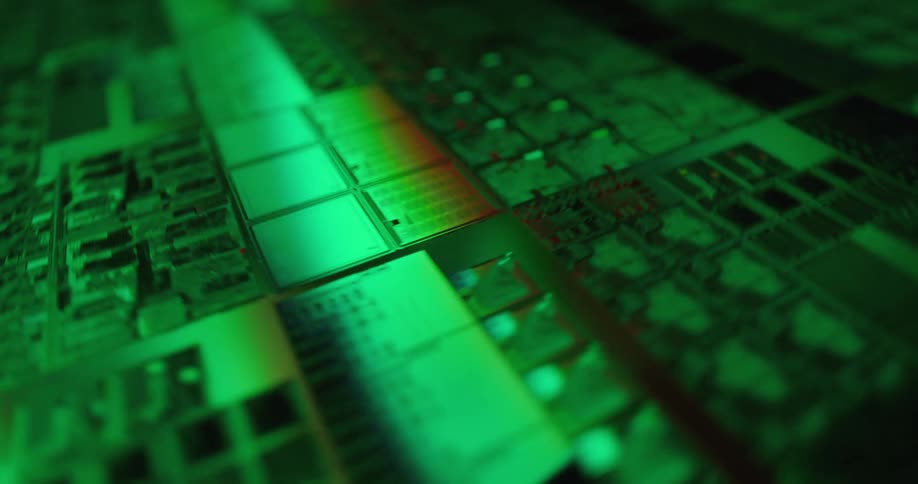 Microchip with electronic circuits and components under intense green lighting