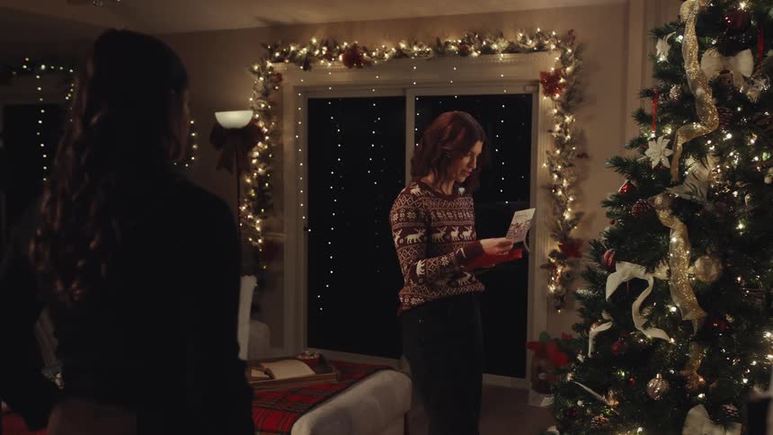Two women exchanging cards and gifts