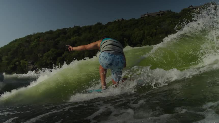 A man surfing outdoors on a wave