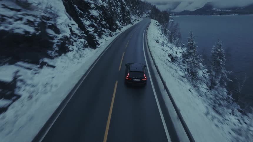 Van traveling on a mountain road along the coast