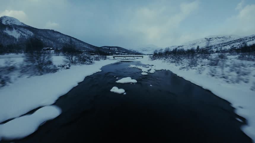 An aerial view of a landscape covered in snow