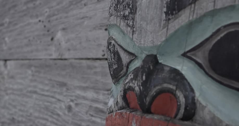 Carved wooden totem with stylized face